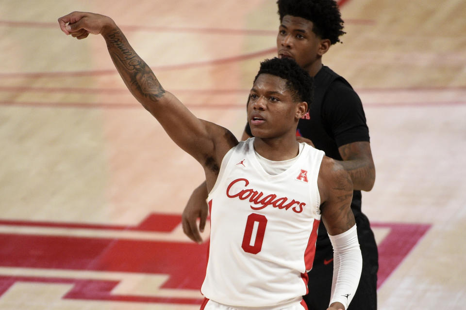 Houston guard Marcus Sasser (0) watches his 3-point basket during the second half of an NCAA college basketball game against SMU, Sunday, Jan. 31, 2021, in Houston. (AP Photo/Eric Christian Smith)