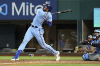 Texas Rangers Joey Gallo (13) follows through on a solo home run in the sixth inning against the Minnesota Twins in a baseball game Sunday, June 20, 2021, in Arlington, Texas. (AP Photo/Richard W. Rodriguez)