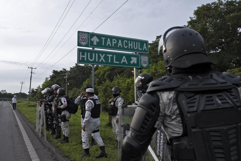 Members of The National Guard block a street during an operation to dissolve a caravan of Central American and Haitian migrants heading to the US, in Huixtla, Chiapas state, Mexico, on September 5, 2021. - A caravan of some 300 mainly Central American people, some carrying children and suitcases, set out from Tapachula on foot Saturday hoping to reach the United States, the fourth such procession in a week. (Photo by JACKY MUNIELLO / AFP) (Photo by JACKY MUNIELLO/AFP via Getty Images)