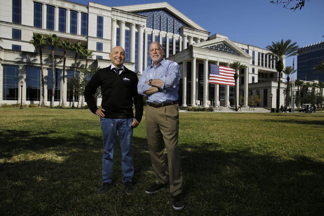 Attorney Mike Freed (left) founder of the Freed to Run fundraiser for Jacksonville Area Legal Aid, and Jim Kowalski, president/CEO of the agency, pose in front of the Duval County Courthouse. The 2023 event Nov. 17-18 will fund legal services for indigent seniors.