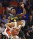 Baylor guard Mark Vital, top, defends against Florida forward Keyontae Johnson, bottom, during the second half of an NCAA college basketball game Saturday, Jan. 25, 2020, in Gainesville, Fla. (AP Photo/Matt Stamey)