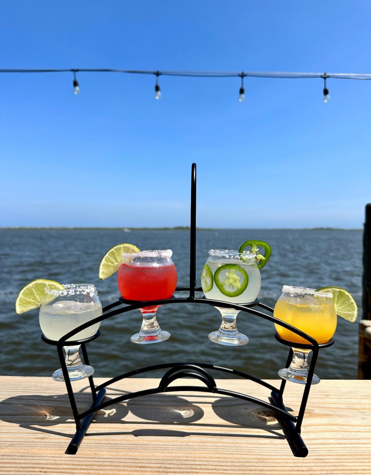 A flight of margaritas featuring (left to right) regular, strawberry, spicy jalapeno and mango from Sun Harbor Seafood and Grill.