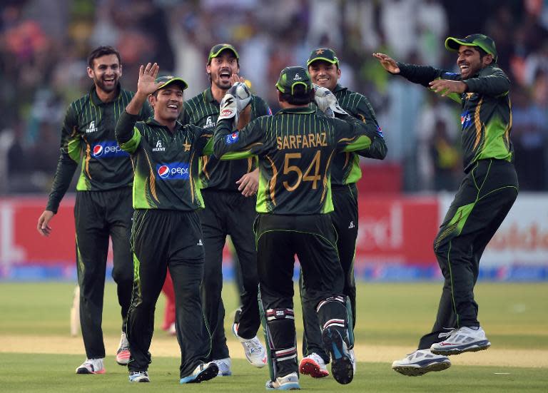 Pakistan cricketers celebrate after the dismissal of Zimbabwe's Chamu Chibhabha for 99 during their second one-day international match at the Gaddafi Cricket Stadium in Lahore, on May 29, 2015