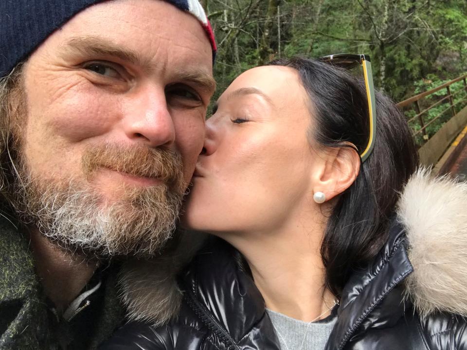 In this photo taken March 3, 2019, Jaclyn Trop is with automotive journalist Davey G. Johnson in Felton, Calif. Authorities using boats and drones are searching a river for Johnson, a veteran automotive journalist who went missing in Northern California while test-driving a motorcycle for a story. Calaveras County Lt. Anthony Eberhardt said Monday, June 10, 2019, crews are searching the Mokelumne River and a reservoir for David Gordon Johnson, who was reported missing June 5. Eberhardt said no foul play is suspected.