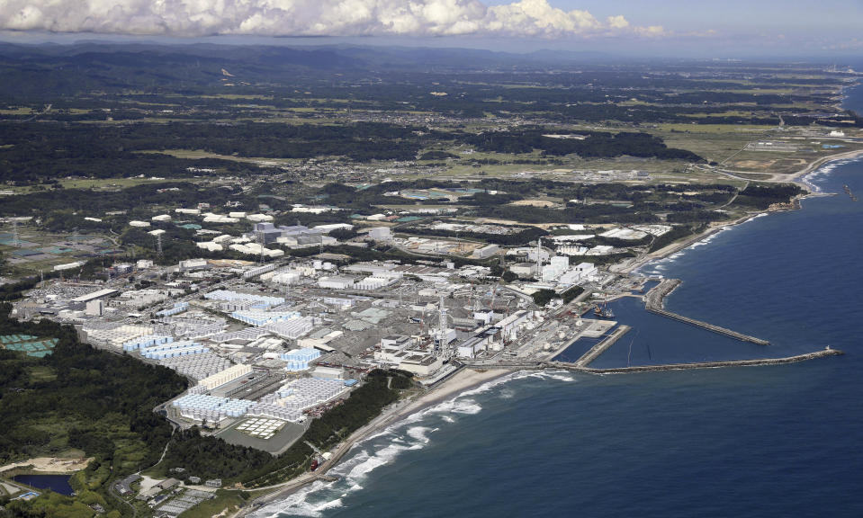 This aerial view shows the tanks, seen foreground, which contain treated radioactive wastewater at the Fukushima Daiichi nuclear power plant in Fukushima, northern Japan, on Aug. 22, 2023. The operator of the tsunami-wrecked Fukushima Daiichi nuclear power plant will begin releasing the first batch of treated and diluted radioactive wastewater into the Pacific Ocean later Thursday, Aug. 24, 2023, utility executives said. (Kyodo News via AP)