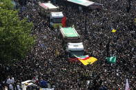 Iranians follow trucks carrying coffins of the late President Ebrahim Raisi and his companions who were killed in a helicopter crash on Sunday in a mountainous region of the country's northwest, during a funeral ceremony for them in Tehran, Iran, Wednesday, May 22, 2024. Iran's supreme leader presided over the funeral Wednesday for the country's late president, foreign minister and others killed in the helicopter crash, as tens of thousands later followed a procession of their caskets through the capital, Tehran. (AP Photo/Vahid Salemi)