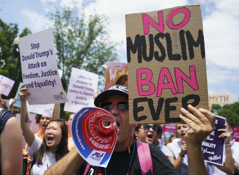 FILE - In this June 26, 2018, file photo, protesters call out against the Supreme Court ruling upholding President Donald Trump's travel ban outside the Supreme Court on Capitol Hill in Washington. Trump’s so-called “travel ban,” stops most visas for residents of mostly Muslim Libya, Iran, Somalia, Syria and Yemen, as well as North Korea and Venezuela. (AP Photo/Carolyn Kaster, File)