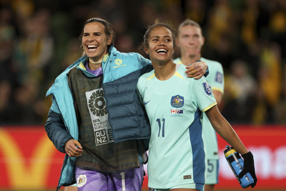 Australia's Mary Fowler and goalkeeper Lydia Williams, left, react at the end of the Women's World Cup Group B soccer match between Australia and Canada in Melbourne, Australia, Monday, July 31, 2023. Australia won 4-0. (AP Photo/Hamish Blair)