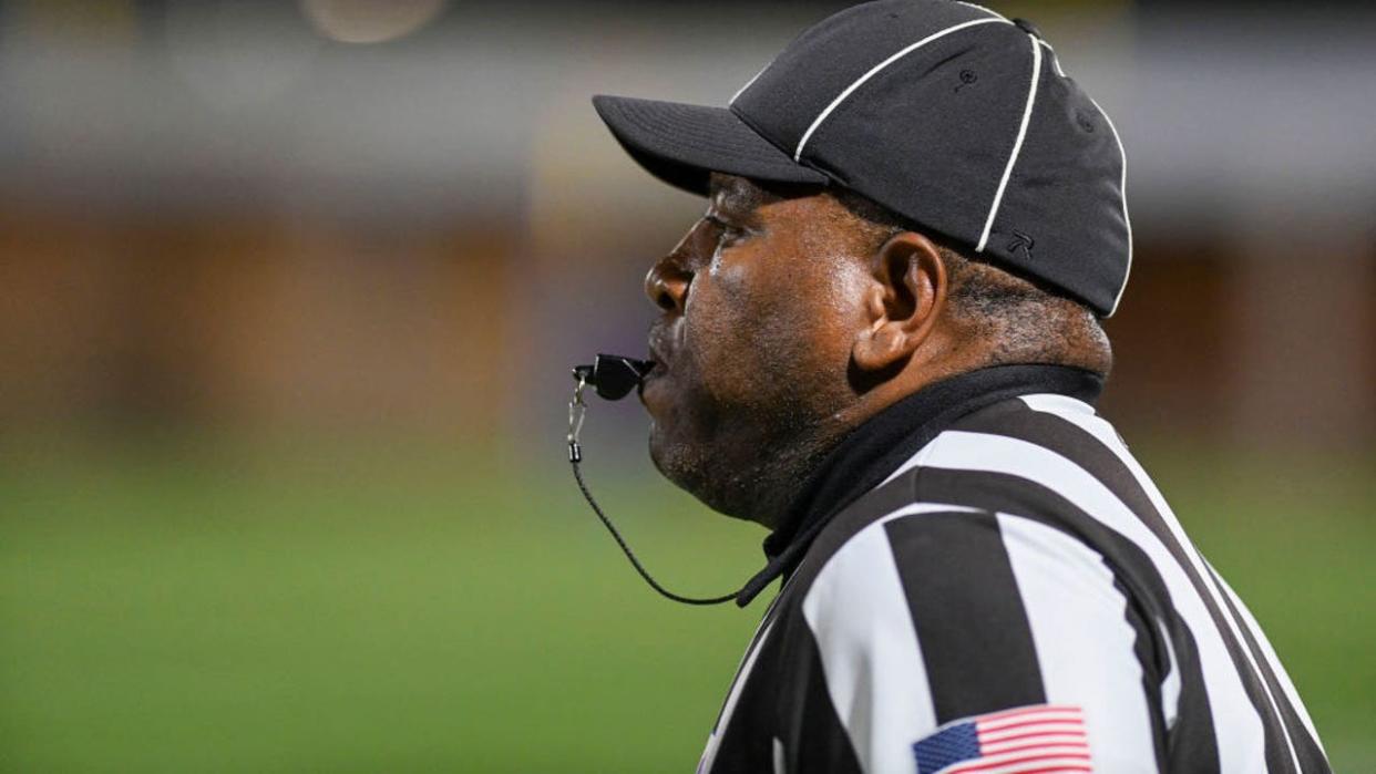 <div>DUMFRIES, VA - OCTOBER 7: Dario Armstrong, commissioner of the Bull Run Districts officials, blows his whistle for an off-sides penalty during the game between Gar-Field and Potomac on October 7, 2022. (Photo by Jonathan Newton/The Washington Post via Getty Images)</div>