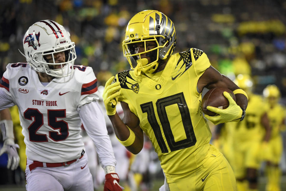 Oregon wide receiver Dont'e Thornton (10) heads to the end zone while being pursued by Stony Brook defensive back Nick Chimienti (25) during the fourth quarter of an NCAA college football game Saturday, Sept. 18, 2021, in Eugene, Ore. (AP Photo/Andy Nelson)