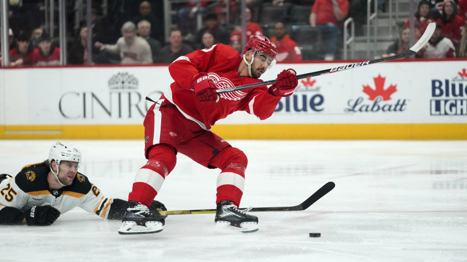 Boston Bruins defenseman Brandon Carlo (25) defends Detroit Red Wings center Joe Veleno (90) in the first period of an NHL hockey game Sunday, March 12, 2023, in Detroit. (AP Photo/Paul Sancya)