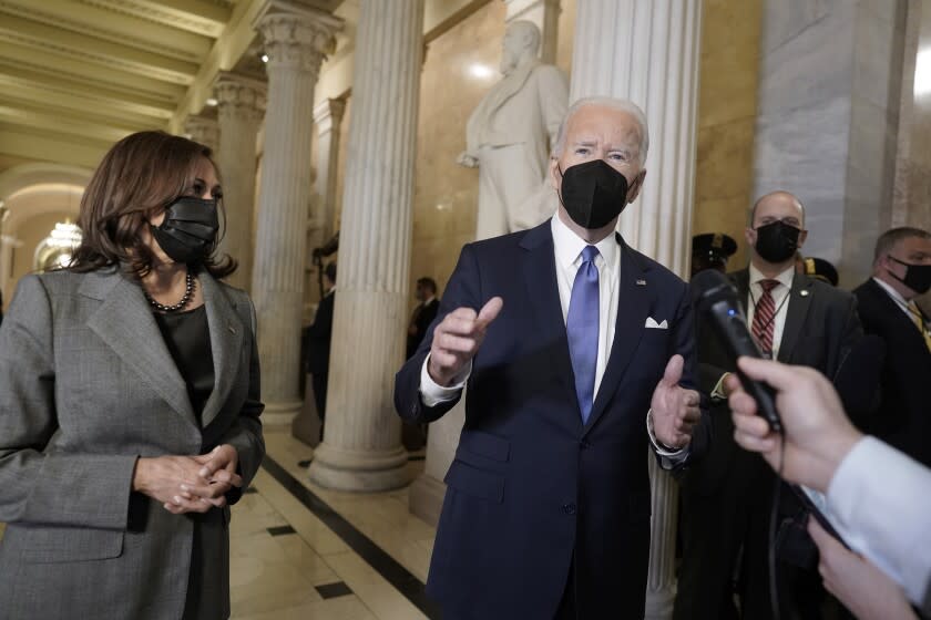 President Joe Biden and Vice President Kamala Harris speak to reporters as the prepare to depart the U.S. Capitol after marking the one year anniversary of the Jan. 6 riot at the Capitol by supporters loyal to then-President Donald Trump, Thursday, Jan. 6, 2022, in Washington. (Ken Cedeno/Pool via AP)