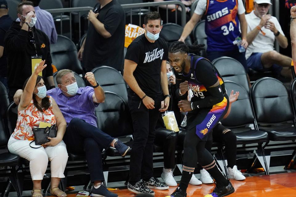 Phoenix Suns forward Jae Crowder celebrates his three-point basket against the Los Angeles Clippers with fans during the second half of Game 1 of the NBA basketball Western Conference finals Sunday, June 20, 2021, in Phoenix. (AP Photo/Ross D. Franklin)