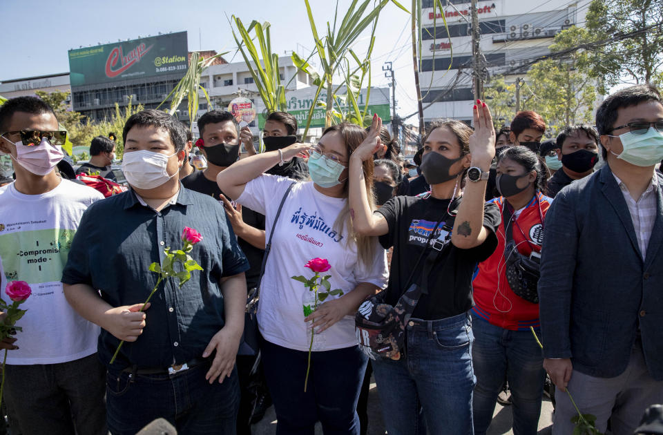 Pro-democracy protest leaders from left, Panupong Jadnok, Parit Chiwarak, Panusaya Sithijirawattanakul, and protest fund-raiser Inthira Charoenpura walk to Bang Khen Metropolitan Police Station, Bangkok, Thailand, Monday, Dec. 21, 2020. Several leaders of protest movement report to the police station to answer the charges of defaming the Thai monarchy, the most serious of many offenses of which they stand accused during recent pro-democracy rallies. (AP Photo/Gemunu Amarasinghe)