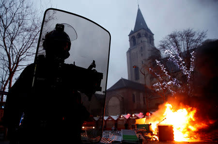 Fire is seen near a Christmas market during a demonstration by the "yellow vests" movement at Boulevard Saint Germain in Paris, France, January 5, 2019. REUTERS/Gonzalo Fuentes