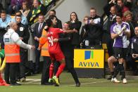 Liverpool's Raheem Sterling celebrates scoring the opening goal of the game with his manager Brendan Rodgers during their English Premier League match against Norwich City at Carrow Road, Norwich, eastern England, Sunday April 20, 2014. (AP Photo/PA, Chris Radburn) UNITED KINGDOM OUT NO SALES NO ARCHIVE