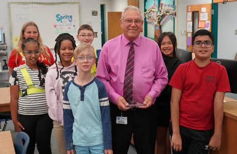 Florida’s 2024 School-Related Employee of the Year, Edward Lanza, poses with students Monday morning at Saddlewood Elementary School in Ocala.