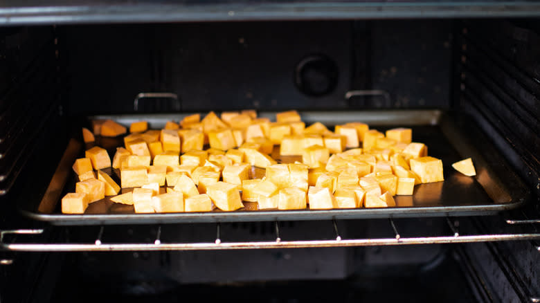 diced sweet potatoes roasting in oven