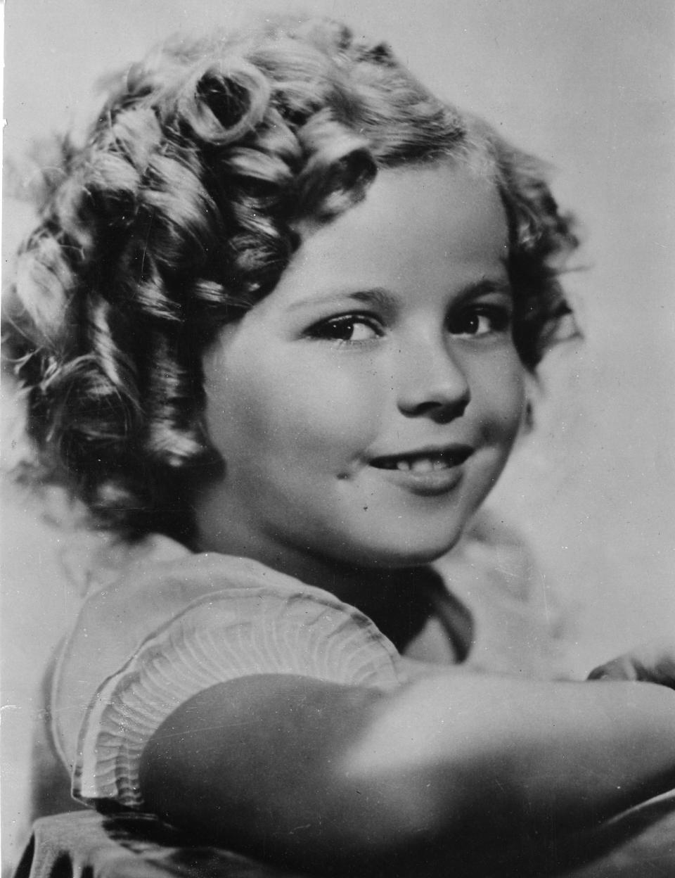 FILE - In this Nov. 1936 file photo, 8-year-old U.S. American child movie star Shirley Temple is portrayed in Hollywood, Ca., USA. Shirley Temple, the curly-haired child star who put smiles on the faces of Depression-era moviegoers, has died. She was 85. Publicist Cheryl Kagan says Temple, known in private life as Shirley Temple Black, died surrounded by family at her home near San Francisco. (AP Photo/File)