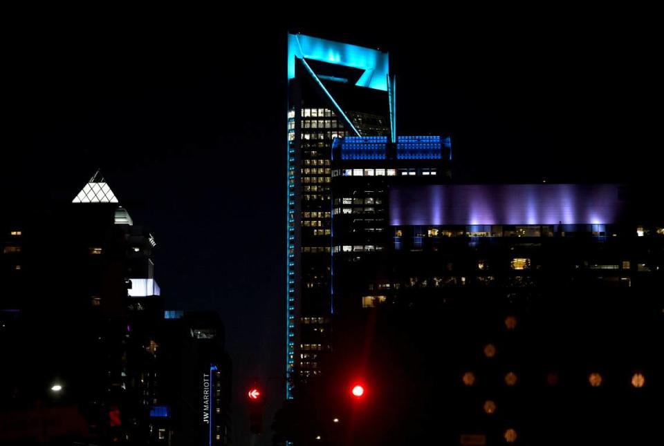 Three Wells Fargo Center at 550 S. Tryon Street and the Duke Energy building are lit in blue light on Monday, April 29, 2024 in Charlotte, NC. Four law enforcement officers were killed and four others injured on Monday when members of a U.S. Marshals Service task force tried to serve a warrant in the Shannon Park area of east Charlotte. Three U.S. Marshals were killed and a CMPD later passed Monday evening.