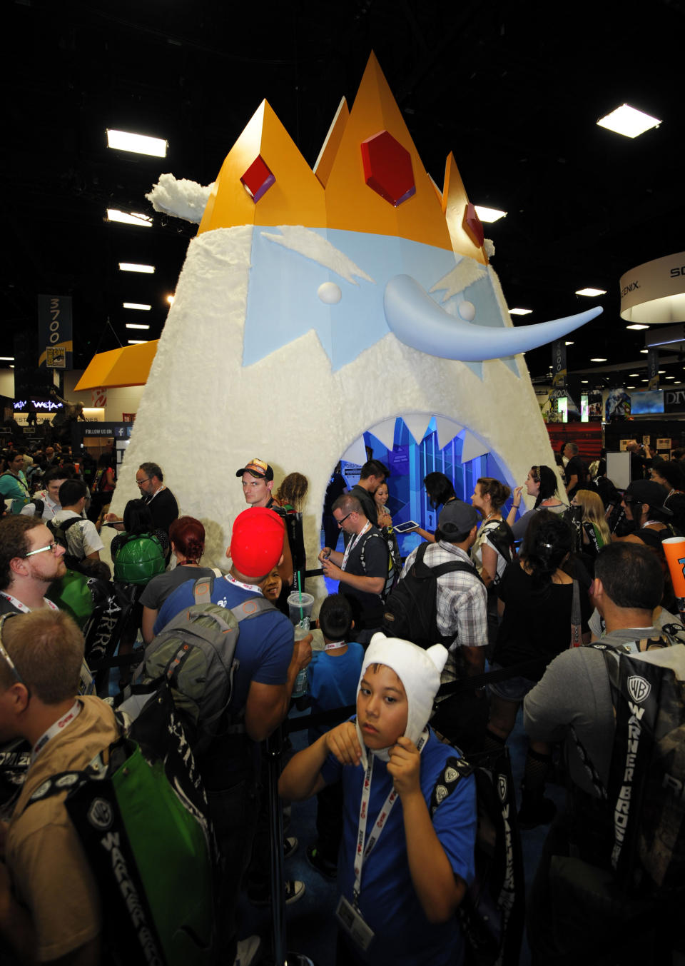 Fans wait to walk through a huge Ice King character at the Cartoon Network booth during the Preview Night event on Day 1 of the 2013 Comic-Con International Convention on Wednesday, July 17, 2013 in San Diego. (Photo by Denis Poroy/Invision/AP)