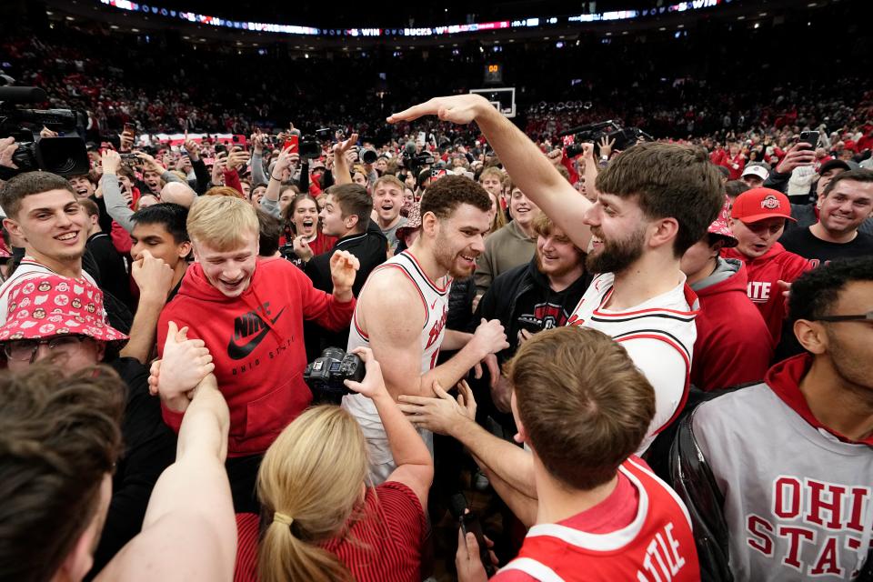 Feb 18, 2024; Columbus, Ohio, USA; Fans storm the court with Ohio State Buckeyes forward Jamison Battle (10) and forward Owen Spencer (44) at the middle following the NCAA men’s basketball game against the Purdue Boilermakers at Value City Arena. Ohio State won 73-69.