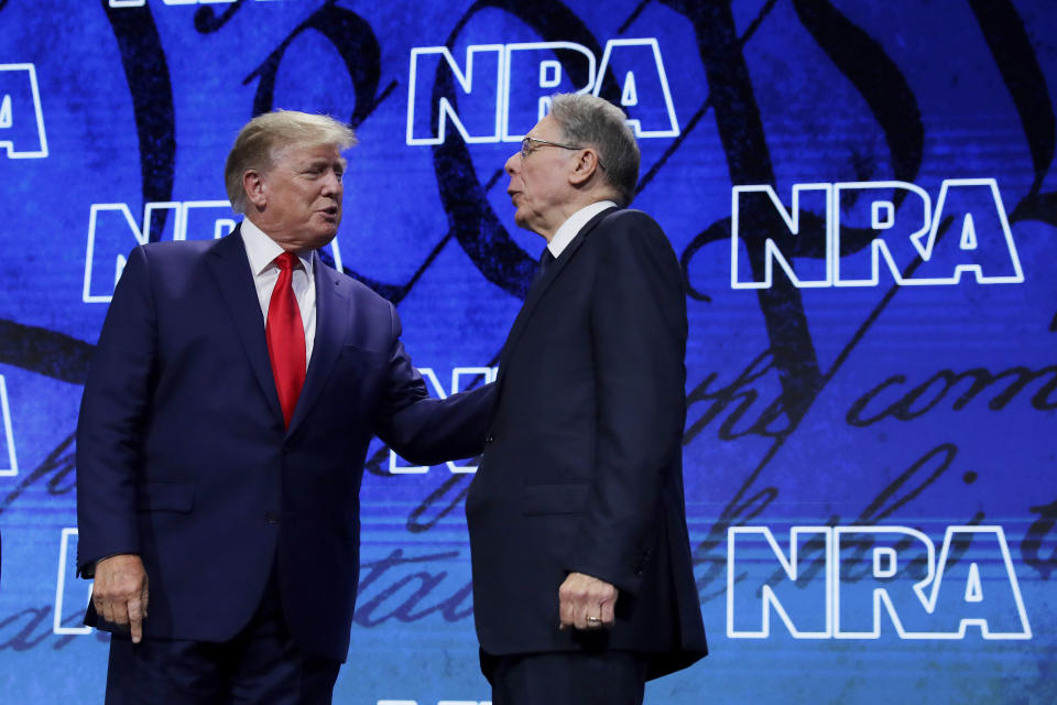NRA executive vice president Wayne Lapierre, right, introduces former president Donald Trump to speak during the Leadership Forum at the National Rifle Association Annual Meeting held at the George R. Brown Convention Center Friday, May 27, 2022, in Houston. (AP Photo/Michael Wyke)