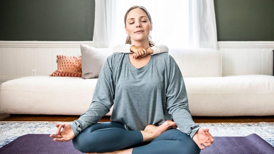 Mother and daughter doing yoga at home