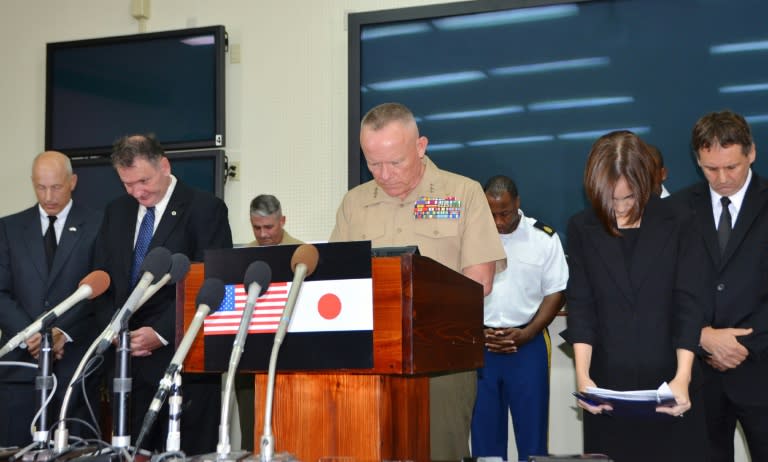 US Marine Corps Lt. Gen. Lawrence D. Nicholson (C) offers a silent prayer for a murdered Japanese woman during a press conference at Camp Foster in Okinawa on May 28, 2016