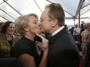 Actress Emma Thompson kisses actor Bradley Whitford as they arrive at the 20th annual Screen Actors Guild Awards in Los Angeles, California January 18, 2014. REUTERS/Mario Anzuoni (UNITED STATES - Tags: ENTERTAINMENT) (SAGAWARDS-ARRIVALS)