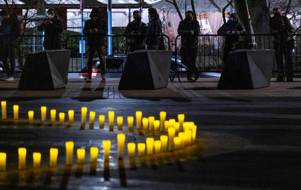 Revson Fountain is lit during a ceremony at Lincoln Center in New York Sunday, March 14, 2021, honoring those who were lost and marking a year after COVID-19 brought much of normal life in New York and the nation to a halt. (AP Photo/Craig Ruttle)