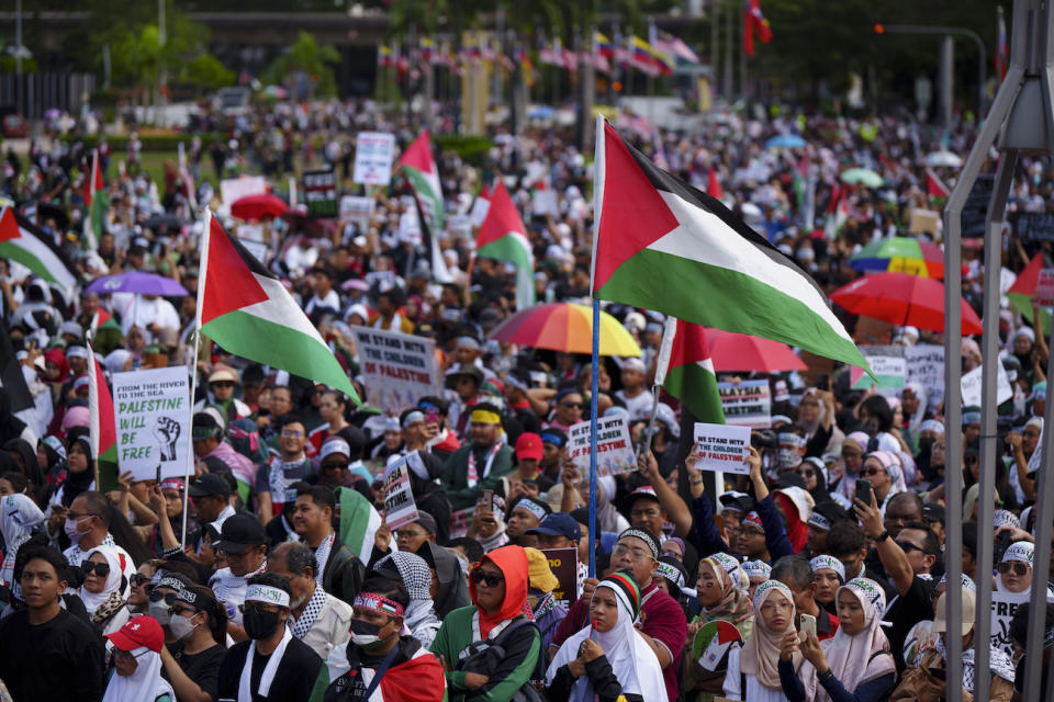 Malaysian Muslims wave Palestinian flags during a rally to show their support for Palestinian people at Independence Square in Kuala Lumpur, Malaysia, Sunday, Oct. 22, 2023. 