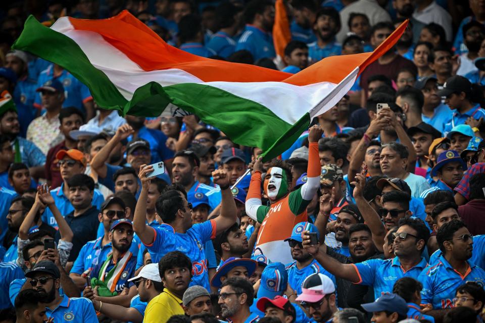 India fans cheering on their country. (Sajjad Hussain/AFP via Getty Images)