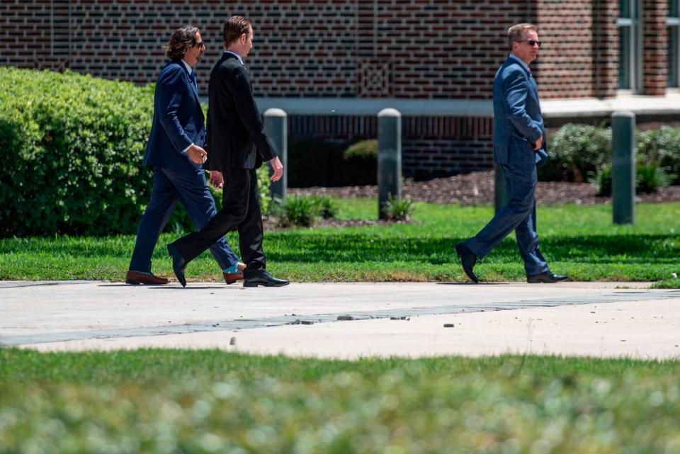 Brandon Reich, center, walks out of Dan M. Russell Federal Courthouse with his lawyers following a court appearance on Wednesday, July 27, 2022. Reich is a co-defendant in a healthcare fraud case involving hoarding personal protective equipment during the pandemic.