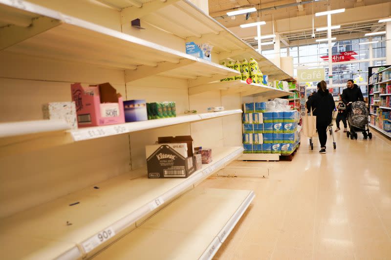 Empty shelves of toilet roll and tissue inside a supermarket, as the number of coronavirus cases grow around the world, in London