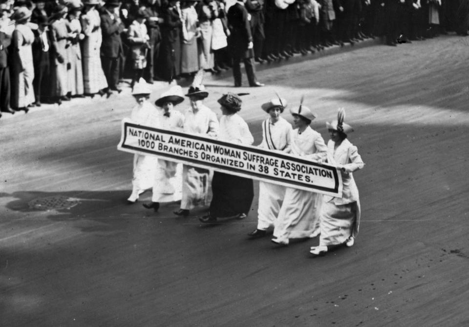 Members of the National American Woman Suffrage Association marching with a banner which publicizes their '1000 branches organized in 38 states' at the New York Suffragette Parade on May 3, 1913.