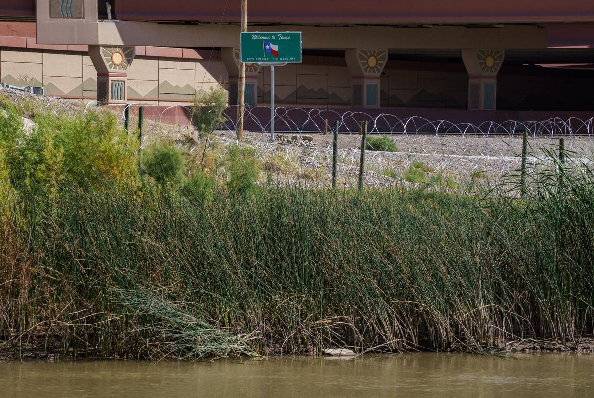 A Welcome to Texas sign stands behind concertina wire set up along the Rio Grande, close to the Texas-New Mexico border in El Paso on Tuesday, Oct. 17, 2023. Texas National Guard troops installed the concertina to prevent migrants who cross in New Mexico from entering Texas.