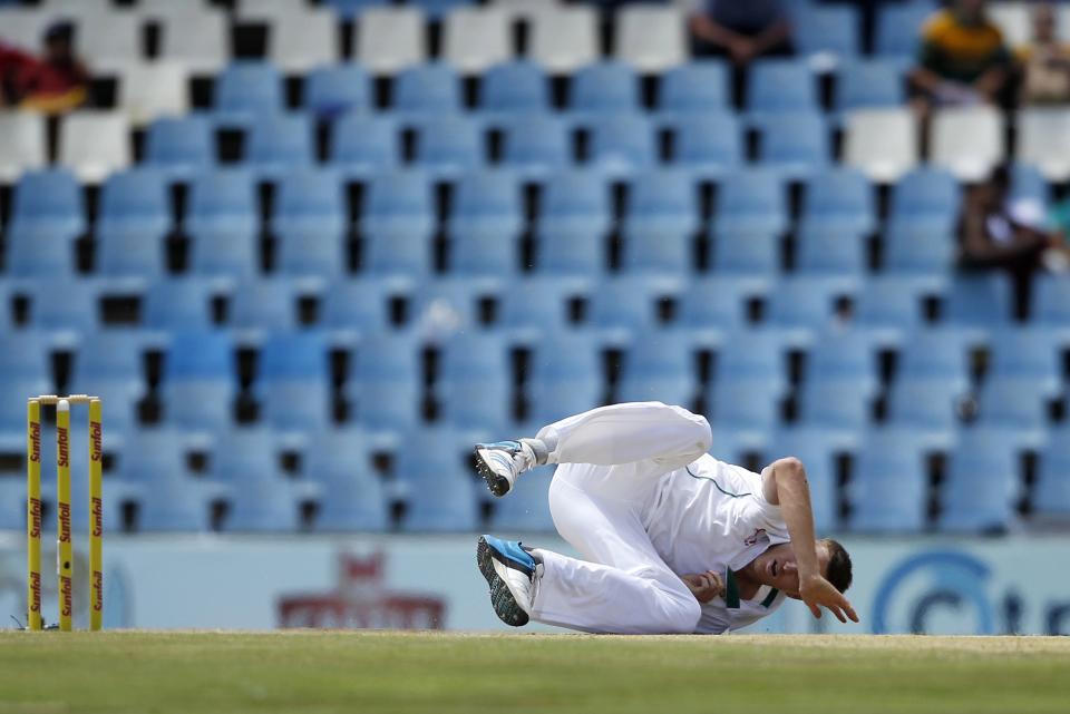 South African paceman Morne Morkel falls after making a delivery during the third day of their cricket test match against Australia in Centurion February 14, 2014. REUTERS/Siphiwe Sibeko (SOUTH AFRICA - Tags: SPORT CRICKET)