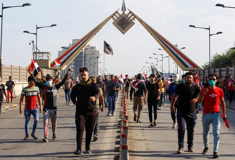 Demonstrators are seen during a protest over corruption, lack of jobs, and poor services, in Baghdad