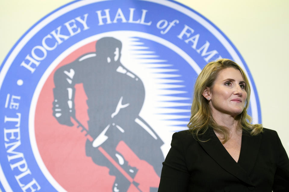 FILE - In this Nov. 15, 2019, file photo, Hockey Hall of Fame inductee Hayley Wickenheiser poses in Toronto. Regional Olympic officials are rallying around the IOC and have backed its stance on opening the Tokyo Games as scheduled. Their support comes one day after direct criticism from athletes amid the coronavirus outbreak. “I think the IOC insisting this will move ahead, with such conviction, is insensitive and irresponsible given the state of humanity,” said Wickenheiser, a four-time Olympic hockey gold medalist from Canada. (Nathan Denette/The Canadian Press via AP, Fle)