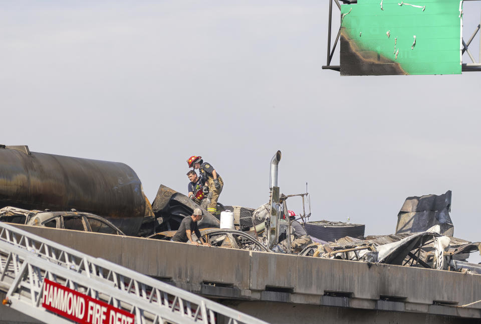 Emergency responders work at the scene of a pileup of vehicles on Interstate 55 near Manchac, La., Monday, Oct. 23, 2023. A “superfog” of smoke from south Louisiana marsh fires and dense morning fog caused multiple traffic crashes involving scores of cars Monday, turning I-55 near New Orleans into a narrow junkyard of mangled cars and trucks, some of them burning. (Brett Duke/The Times-Picayune/The New Orleans Advocate via AP)