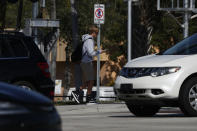 A person approaches a train track in front of a sign that says "no trespassing" over the train tracks on Wednesday, Nov. 27, 2019, in Oakland Park, Fla. After Richard Branson announced his Virgin Group would partner with Brightline, Florida's new higher-speed passenger rail service, a train whisked the British billionaire, VIPs and journalists from Miami to West Palm Beach in just over an hour and then back, with no problems. (AP Photo/Brynn Anderson)