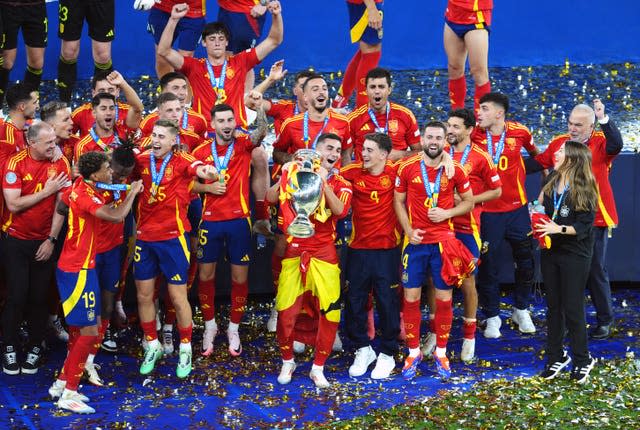 Spain players celebrate with the Henri Delaunay Cup