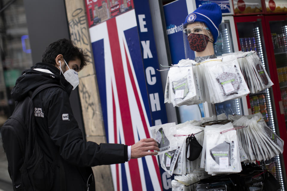 LONDON, ENGLAND - OCTOBER 13: A shopper looks at face masks on Oxford Street on October 13, 2020 in London, England. London Mayor Sadiq Khan said today that the city would move into Tier 2 of the government's new covid-19 risk classification once it hits 100 new daily cases per 100,000 people, which could happen this week. The second or "high" tier of the three-tier system triggers a ban on household mixing, although pubs would remain open. (Photo by Dan Kitwood/Getty Images)