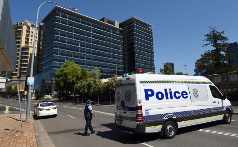 Police block off the scene near New South Wales Police Headquarters where a 15-year-old gunman shot dead a civilian police employee the previous day, before being gunned down by police in Sydney on October 3, 2015