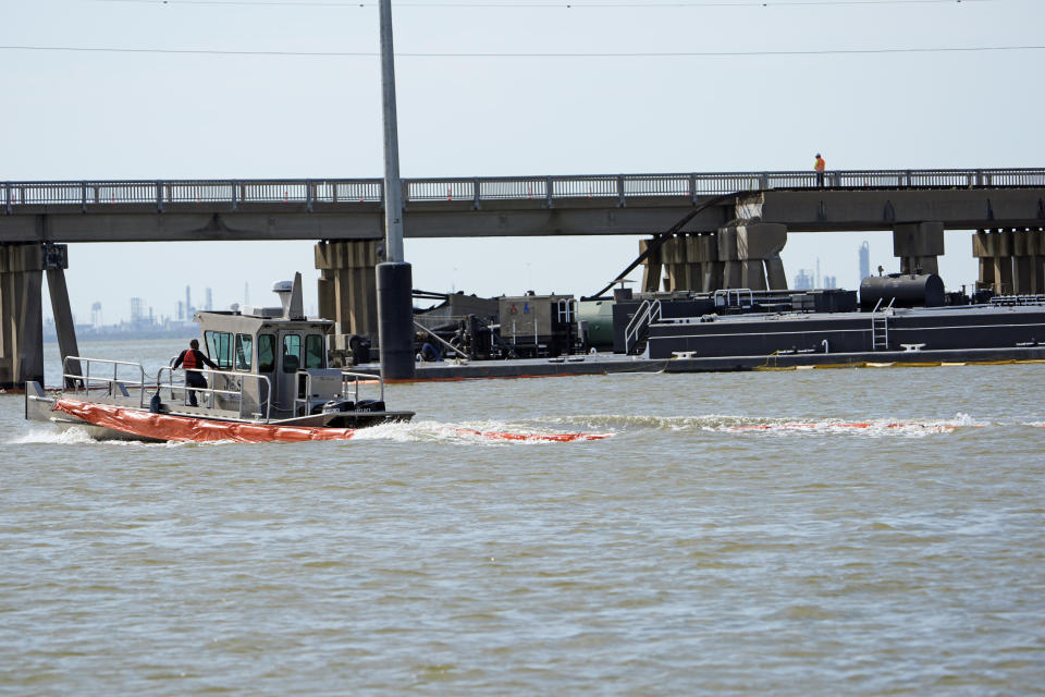 An spill boom is moved into position to contain a leak from a barge that crashed into the Pelican Island Bridge, Wednesday, May 15, 2024, in Galveston, Texas. (AP Photo/David J. Phillip)