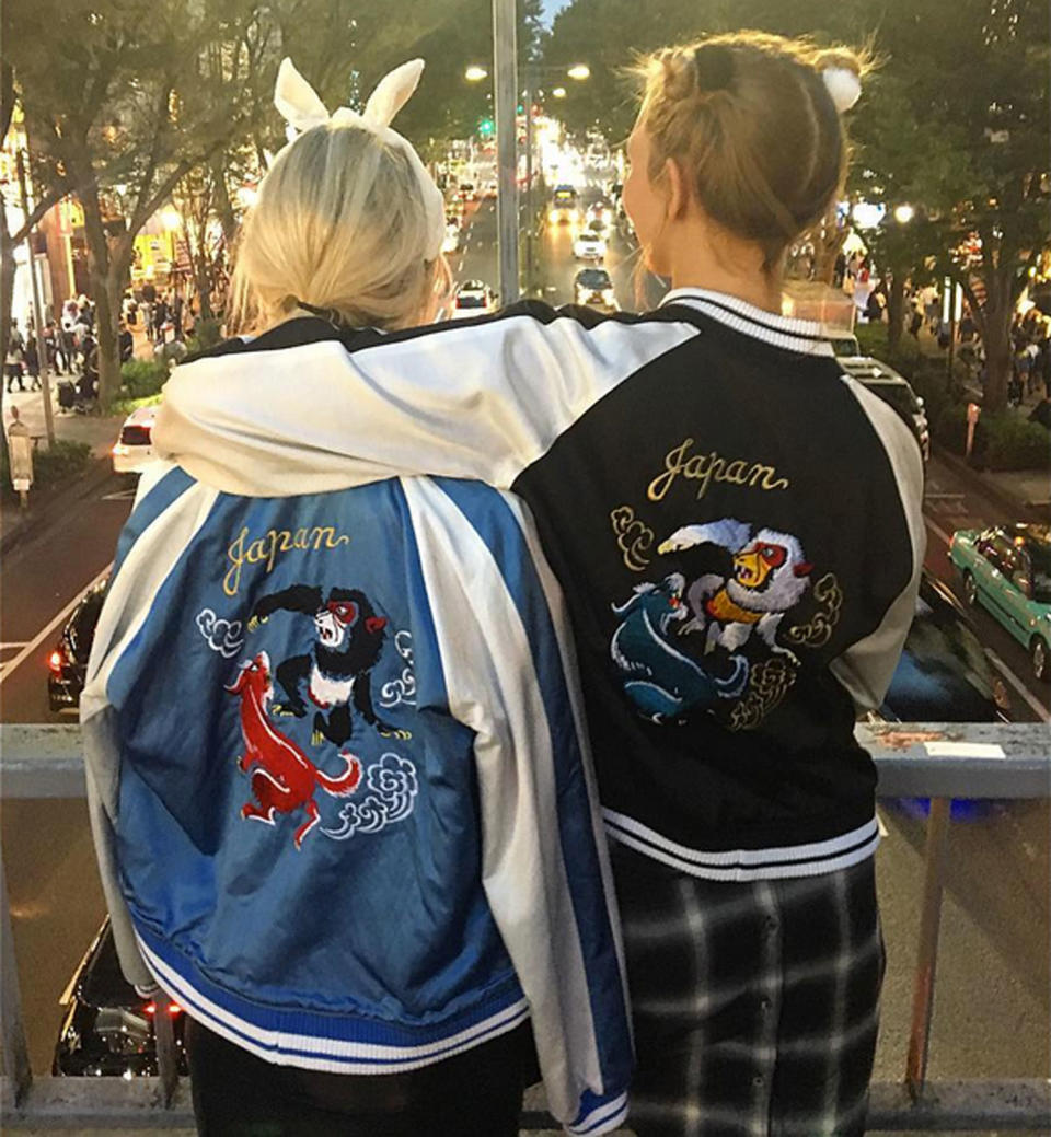 Karlie Kloss takes in the street scene in Tokyo's Shibuya neighborhood with her sister, Kimby. 