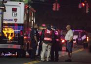 A resident speaks with authorities in Stamford, Connecticut, October 3, 2013. Federal agents, bomb squad units and local police searched the Stamford Connecticut residence of a woman who led law enforcement officers on a dramatic car chase near the White House to the U.S. Capitol which ended when law enforcement officers shot and killed the driver, media reported. (REUTERS/Michelle McLoughlin)