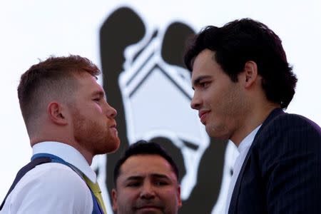 Mexico's boxers Canelo Alvarez, (L), and Julio Cesar Chavez, Jr. go head to head during a news conference ahead of WBC brawl in Las Vegas, in Mexico City, Mexico, February 20, 2017. REUTERS/Carlos Jasso