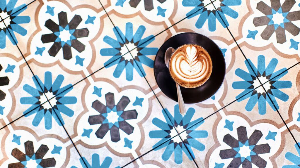 A cup of coffee on a tiled floor